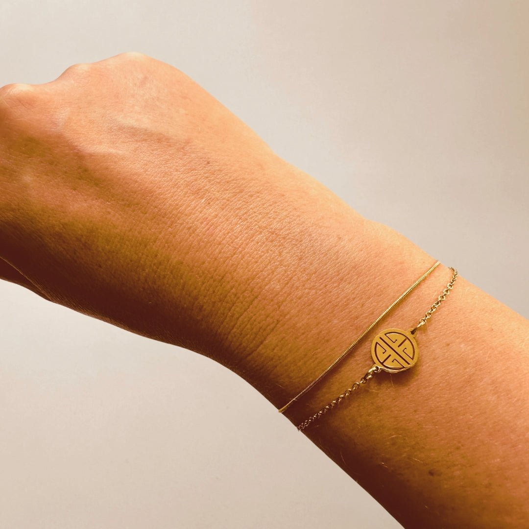 Armband goud rijkdom symbool - Sieradenkaart